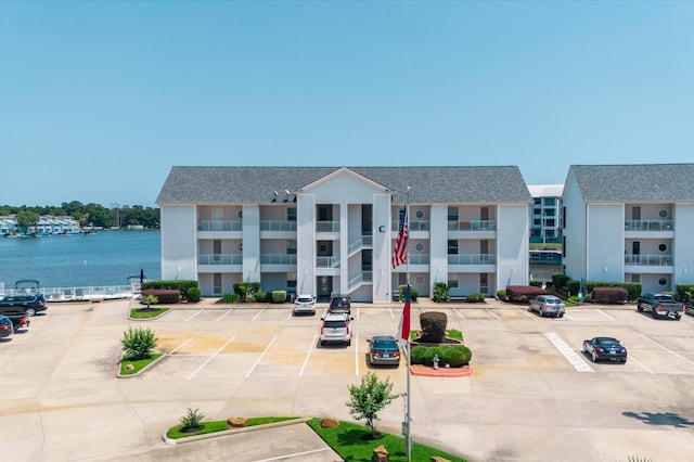 168 Lake Point Blvd Unit C202, Conroe, TX 77356 - view of property featuring uncovered parking and a water view