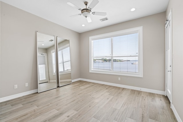 unfurnished room with ceiling fan and light hardwood / wood-style flooring