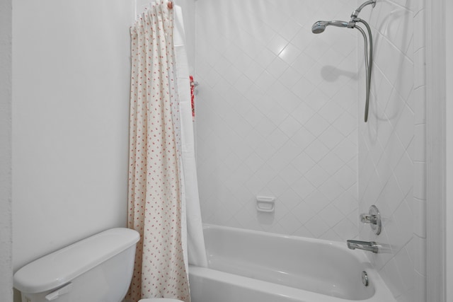 bathroom featuring toilet and shower / bathtub combination with curtain