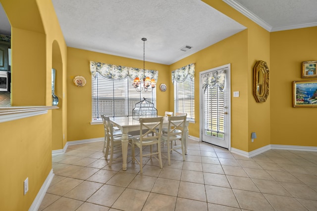 dining area with ornamental molding, a healthy amount of sunlight, and light tile patterned flooring