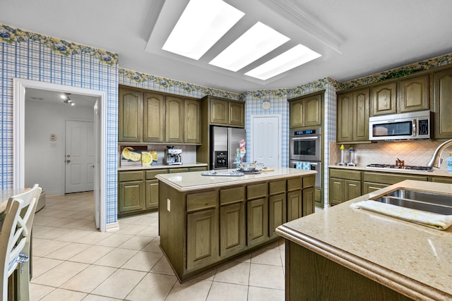 kitchen with tasteful backsplash, light tile patterned floors, stainless steel appliances, sink, and a center island