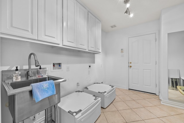 laundry area featuring light tile patterned floors, electric dryer hookup, washer hookup, and cabinets