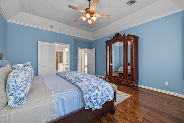 bedroom featuring a textured ceiling, dark hardwood / wood-style flooring, ceiling fan, connected bathroom, and crown molding