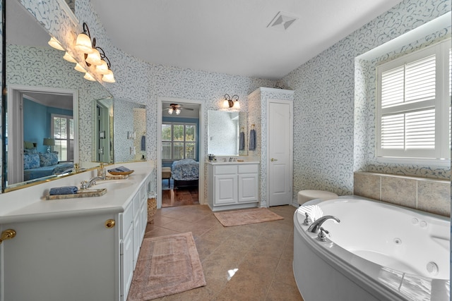 bathroom with vanity, ceiling fan, tile patterned flooring, and a washtub