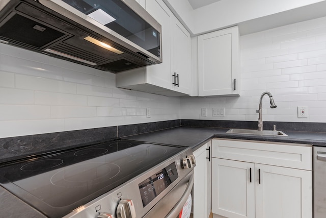 kitchen with sink, white cabinets, and appliances with stainless steel finishes