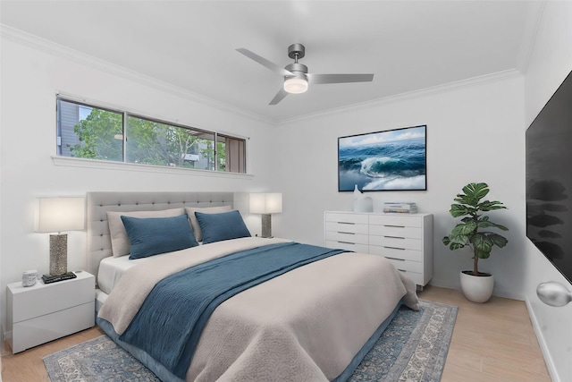 bedroom featuring ornamental molding, ceiling fan, and light wood-type flooring