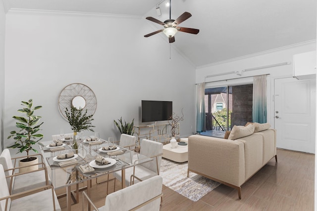 living room featuring ceiling fan, hardwood / wood-style floors, high vaulted ceiling, and crown molding