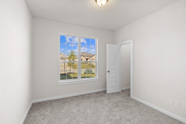 unfurnished room with light carpet