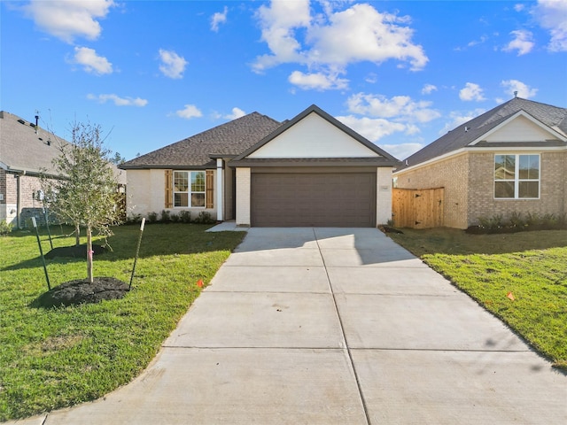 single story home featuring a garage and a front yard