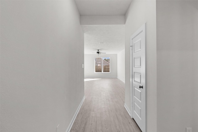 hallway with light hardwood / wood-style floors