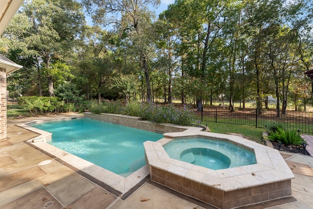 view of pool featuring an in ground hot tub and a patio