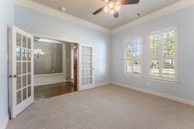 unfurnished room with ceiling fan with notable chandelier, ornamental molding, carpet flooring, and french doors