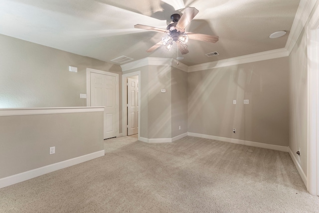 carpeted empty room featuring ceiling fan and ornamental molding