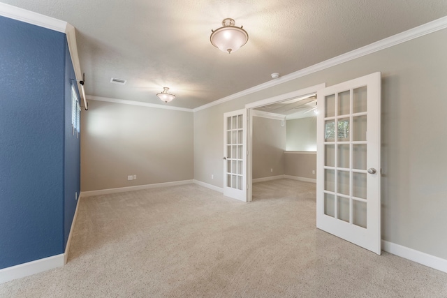 empty room featuring crown molding and french doors