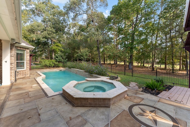 view of pool with an in ground hot tub and a patio