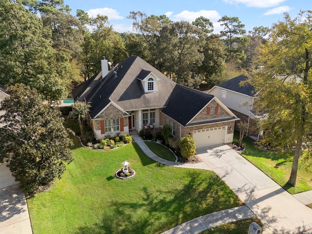 view of front of property with a garage and a front lawn