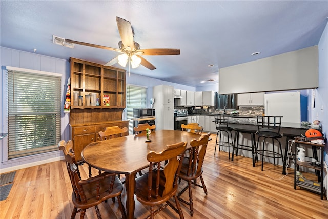 dining space featuring light hardwood / wood-style floors and ceiling fan