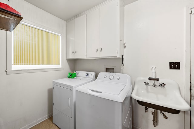 laundry area featuring sink, independent washer and dryer, and cabinets