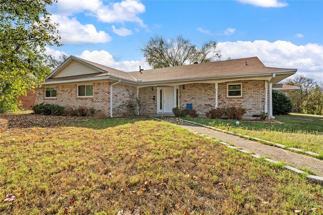 ranch-style home featuring a front yard