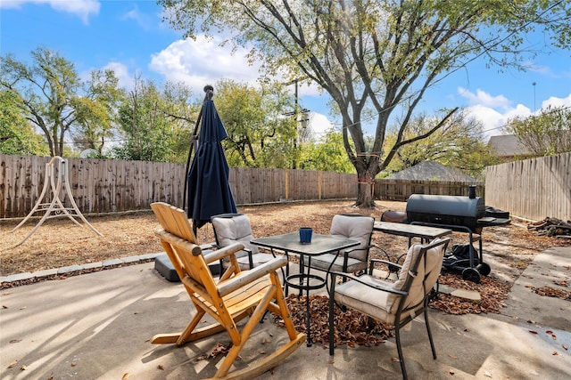 view of patio featuring a fenced backyard and outdoor dining space