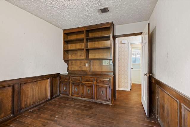 unfurnished office featuring dark hardwood / wood-style flooring and a textured ceiling