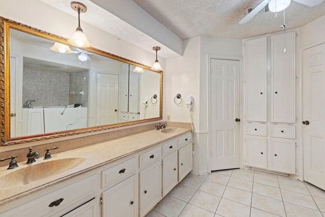 bathroom featuring ceiling fan, tile patterned flooring, vanity, and a textured ceiling