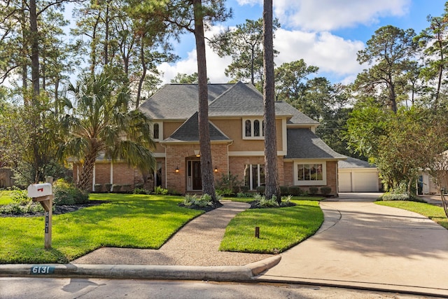 view of front of property with a garage and a front yard