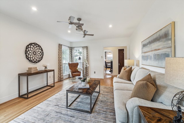 living room with hardwood / wood-style flooring and ceiling fan