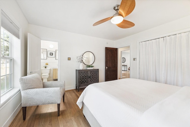 bedroom featuring wood-type flooring, ceiling fan, and ensuite bathroom