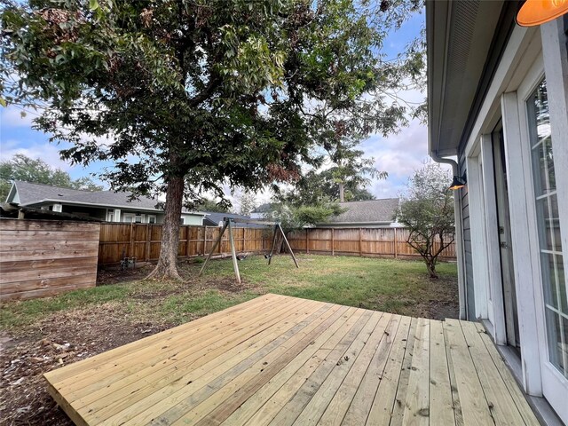 deck featuring a yard and a playground