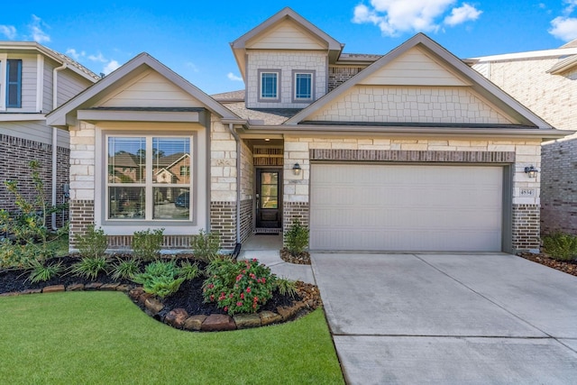 view of front of home with a front yard and a garage