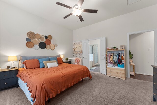 bedroom with dark colored carpet, ensuite bathroom, and ceiling fan