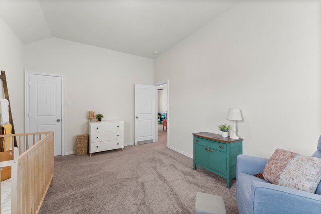 sitting room featuring vaulted ceiling and light colored carpet