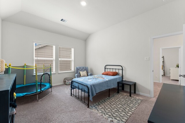 bedroom featuring light carpet and vaulted ceiling