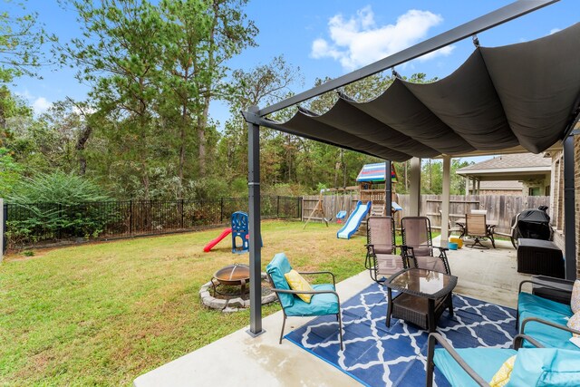 view of patio with an outdoor fire pit and a playground