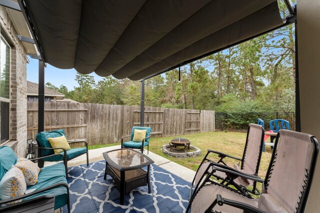 view of patio / terrace with an outdoor living space with a fire pit