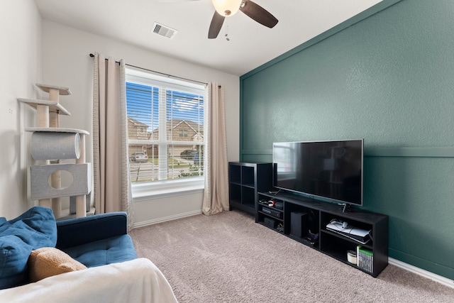 living room with ceiling fan, lofted ceiling, and light colored carpet