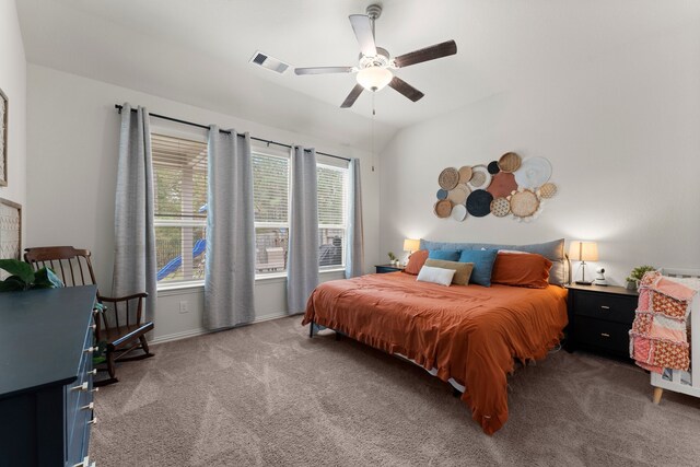 carpeted bedroom featuring multiple windows and ceiling fan