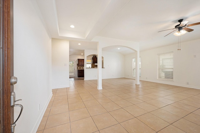 unfurnished living room with recessed lighting, arched walkways, ceiling fan, and light tile patterned floors