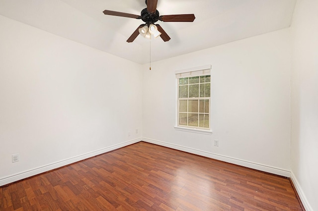 spare room featuring baseboards, ceiling fan, and wood finished floors