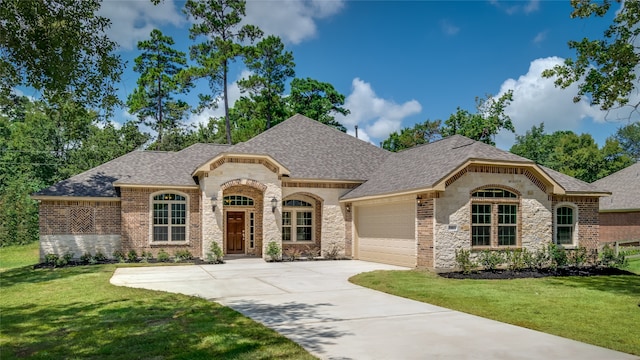 view of front of house with a front yard and a garage