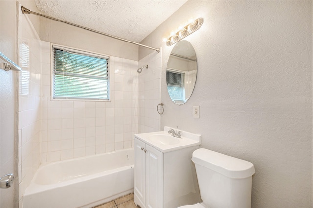 full bathroom featuring a textured ceiling, toilet, vanity, tiled shower / bath combo, and tile patterned flooring