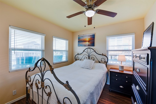 bedroom with dark wood-type flooring and ceiling fan