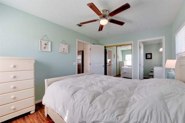 bedroom featuring a closet, a textured ceiling, wood-type flooring, and ceiling fan