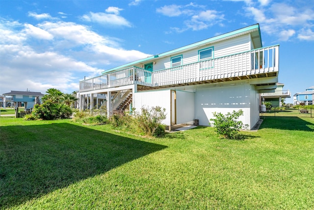 rear view of property featuring a wooden deck and a lawn