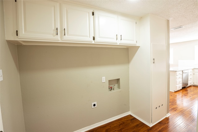 clothes washing area featuring cabinets, hardwood / wood-style floors, washer hookup, a textured ceiling, and hookup for an electric dryer