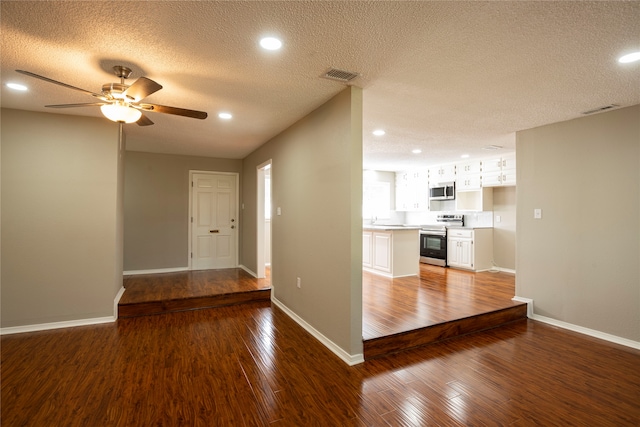 interior space with sink, a textured ceiling, wood-type flooring, and ceiling fan