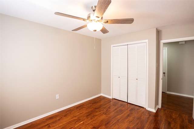 unfurnished bedroom featuring a closet, dark wood-type flooring, and ceiling fan