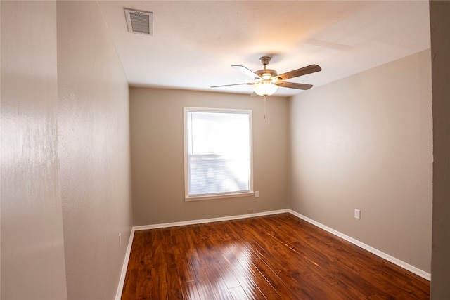 empty room featuring dark wood-type flooring and ceiling fan