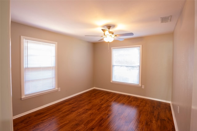 spare room with ceiling fan and dark hardwood / wood-style flooring